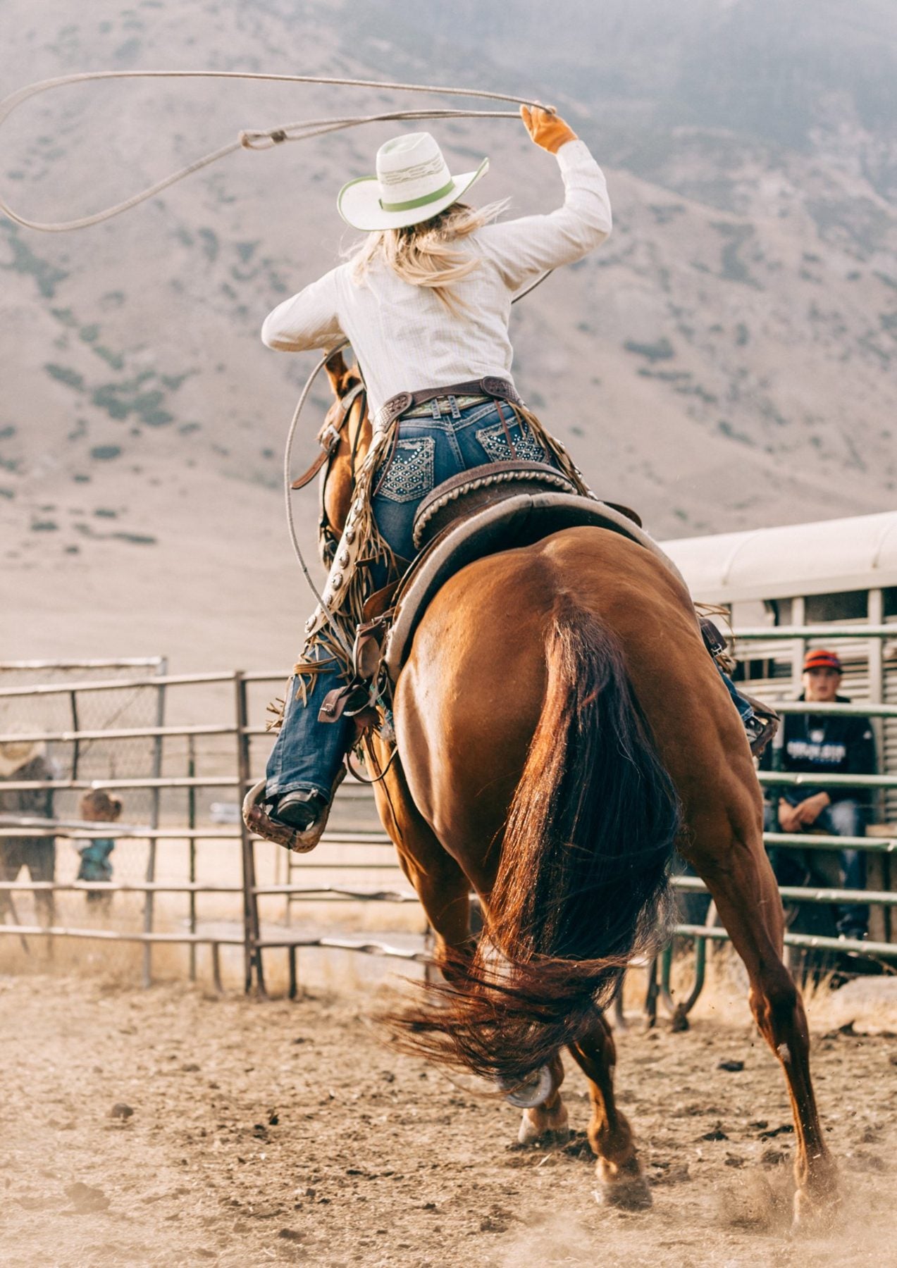 Cowgirl swinging a lasso