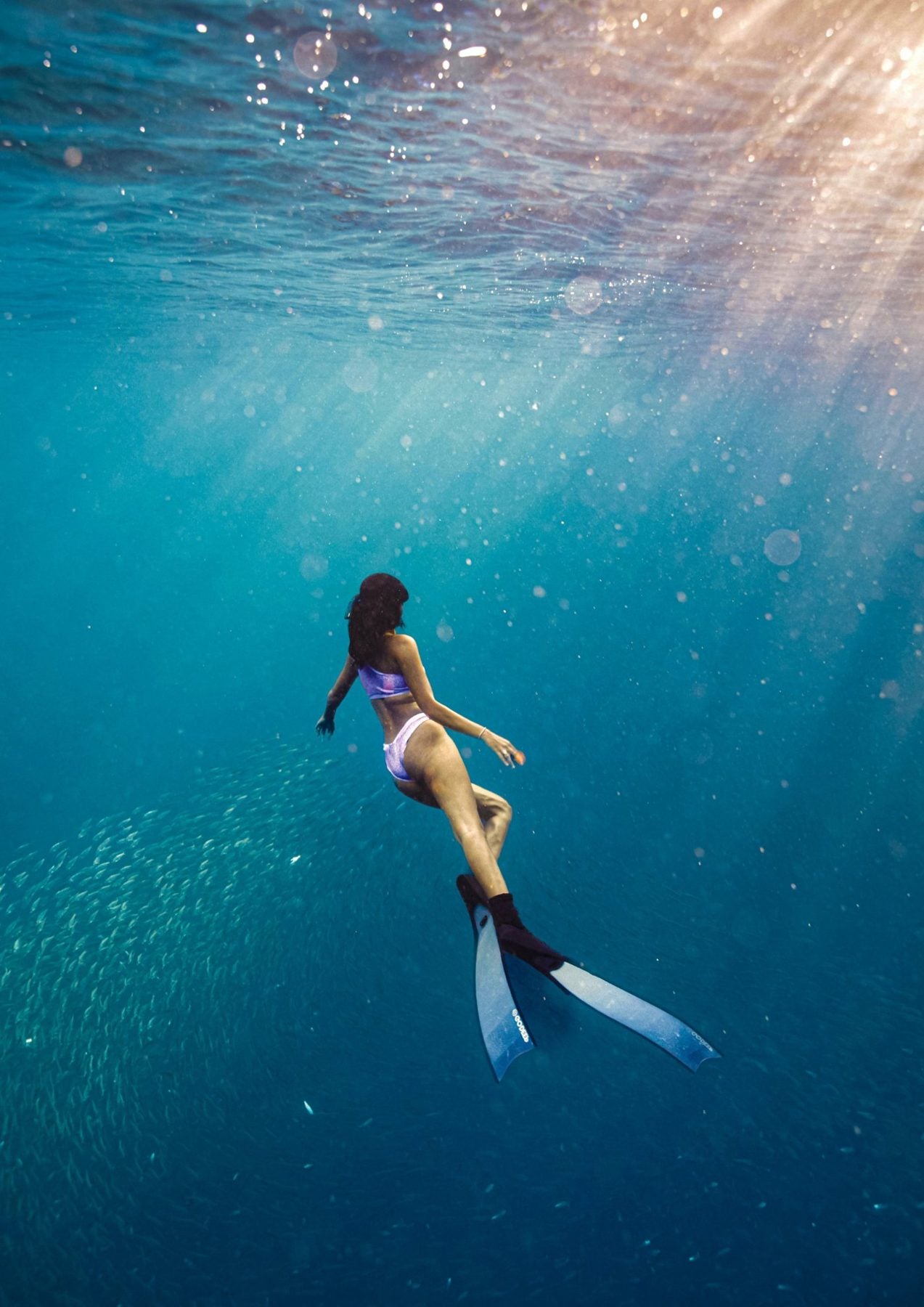 Freediver under clear blue water