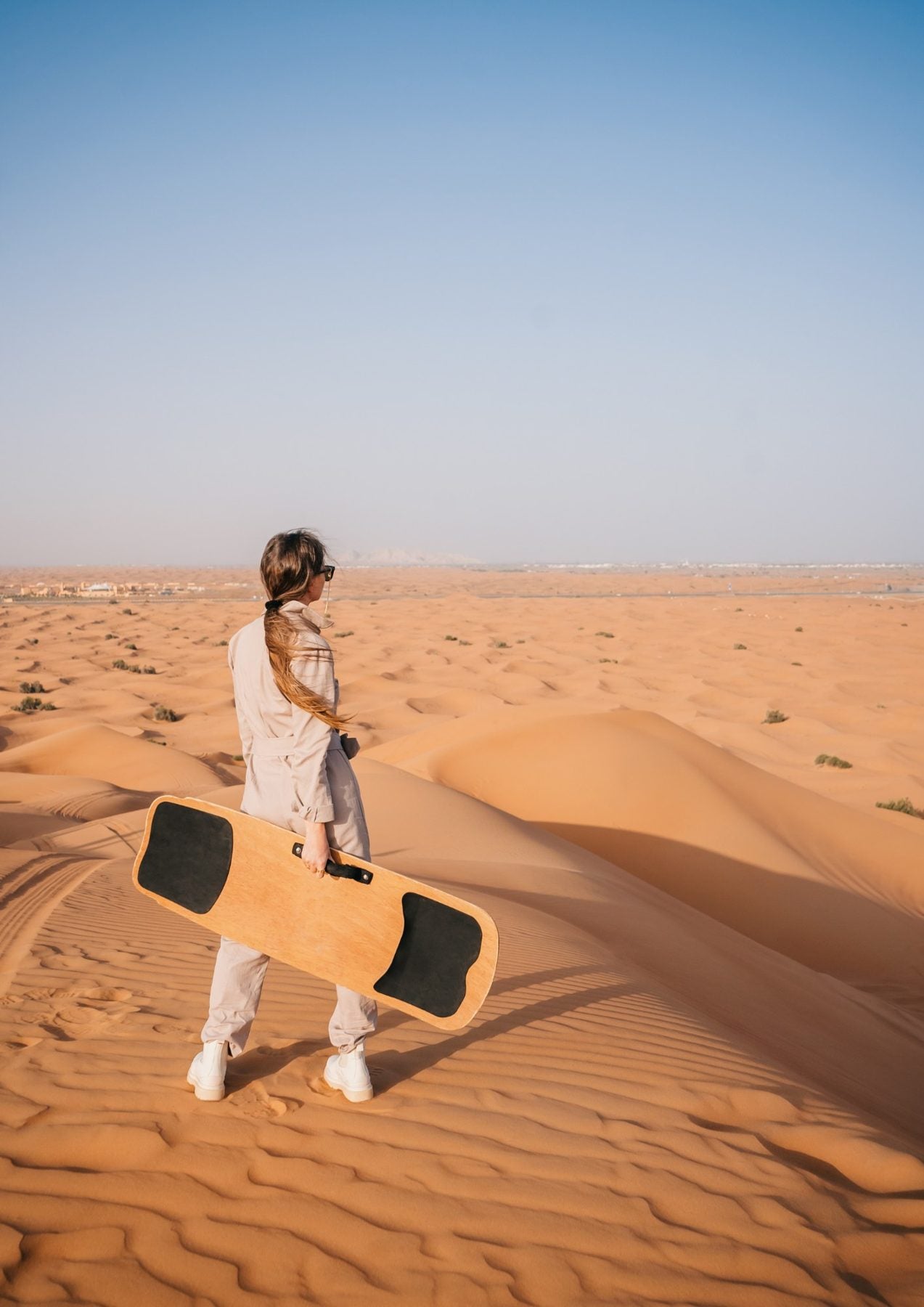 Sandboarding down a dune